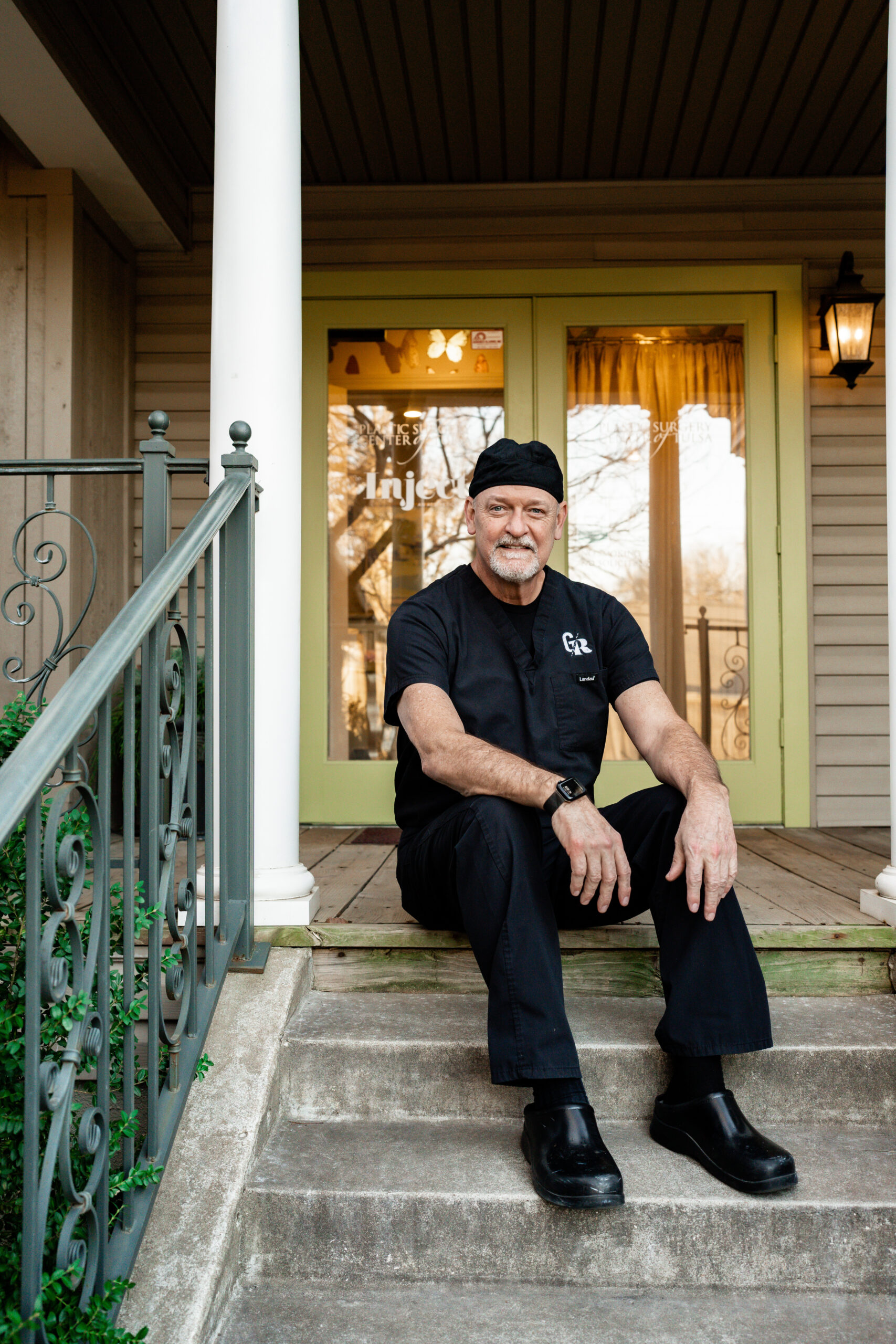 Doctor sitting on a front porch stair case
